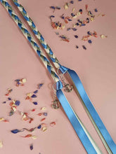 Load image into Gallery viewer, Intertwined Handfasting Cords made from blue, ivory and green strands of satin ribbon, along with silver anchor charms.  Set against a pink backdrop with confetti.

